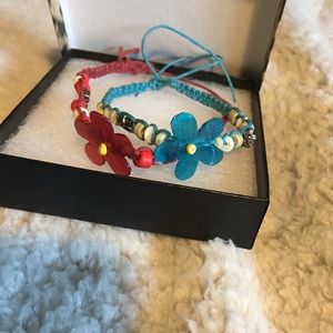 A red and a blue handmade flower bracelets
